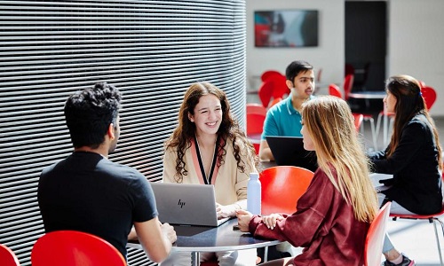 Three people are sitting at the table talking with each other, they are applying to Imperial College London - Economic, Finance, and Data Science.