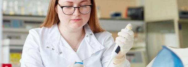 A student in Swansea University Medical School - Applied Medical Sciences, BSc (Hons), is using a syringe to test her experiment.