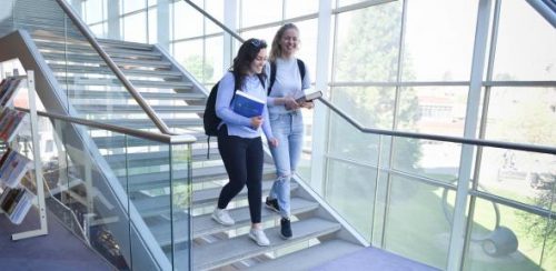 two undergraduated students are wslking down the stairs at Law - University of Cambridge