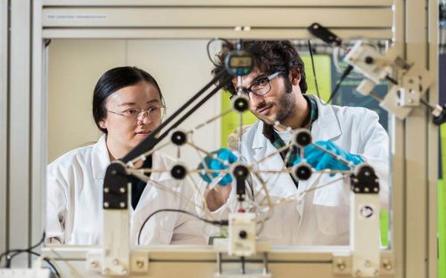 two civil engineering students in UCL are testing their experiment.